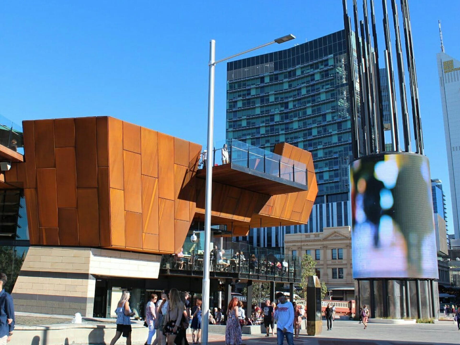 curved led video wall on display in an outdoor, urban space