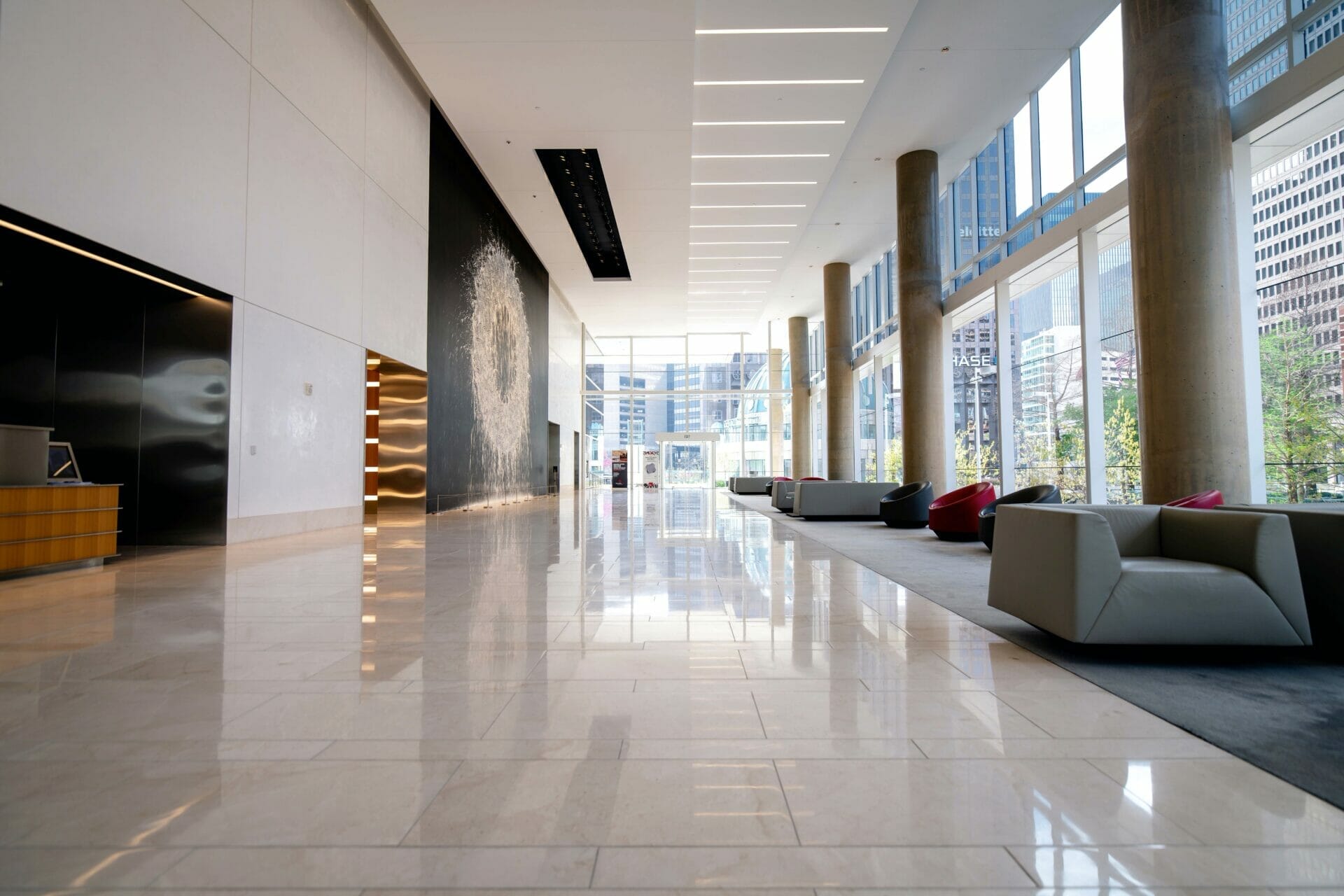 a corporate office lobby setting with an led display and lounge area